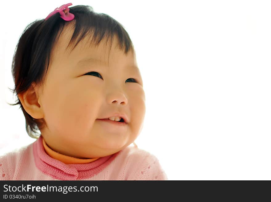 A Asian baby girl sitting on the bed