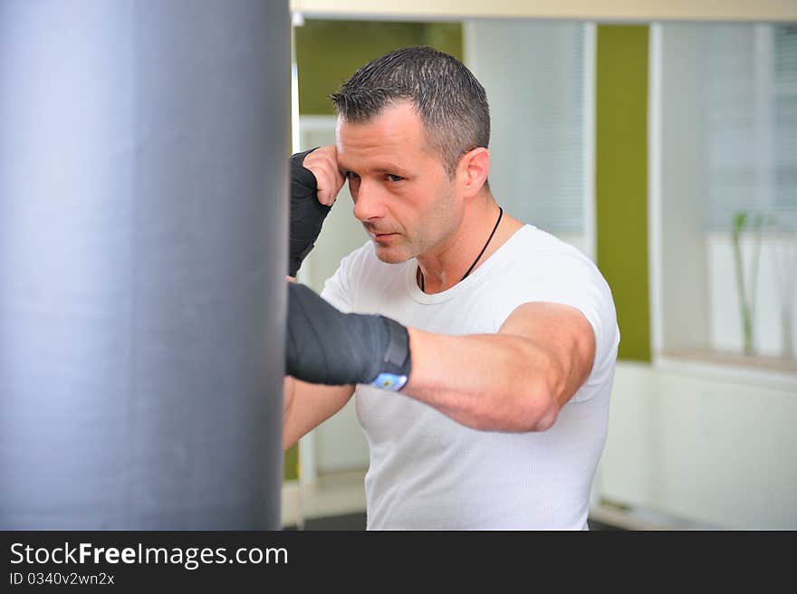 Boxer in training on the punching bag.