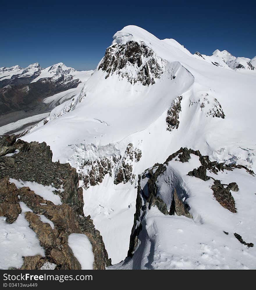 A view of a snowcovered mountain in the swiss alps. A view of a snowcovered mountain in the swiss alps