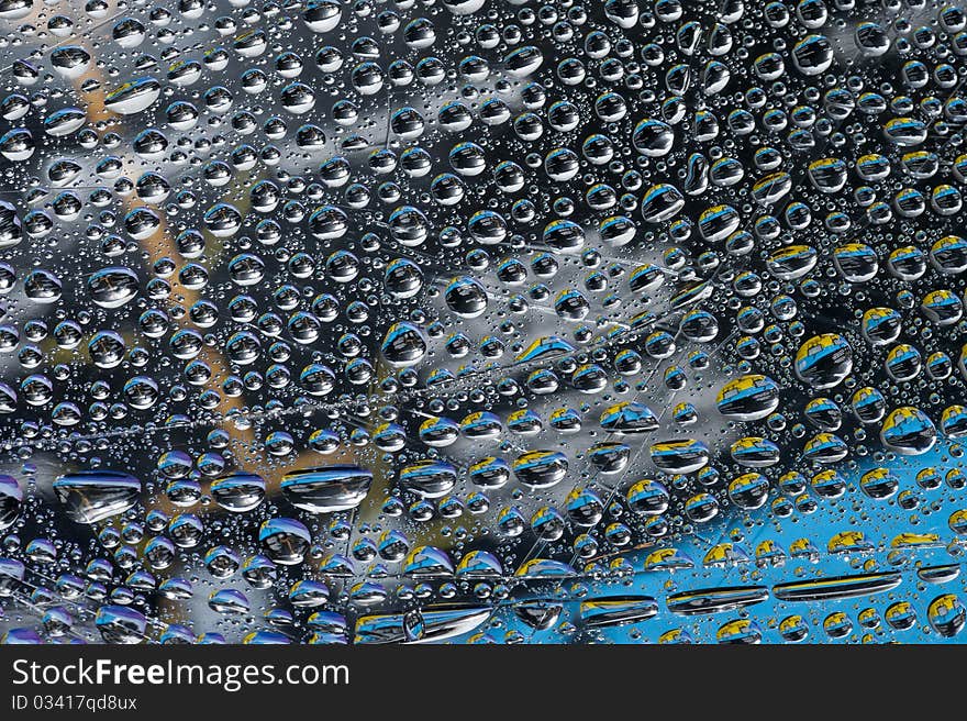 Background with color water drop. Rain drop on the glass