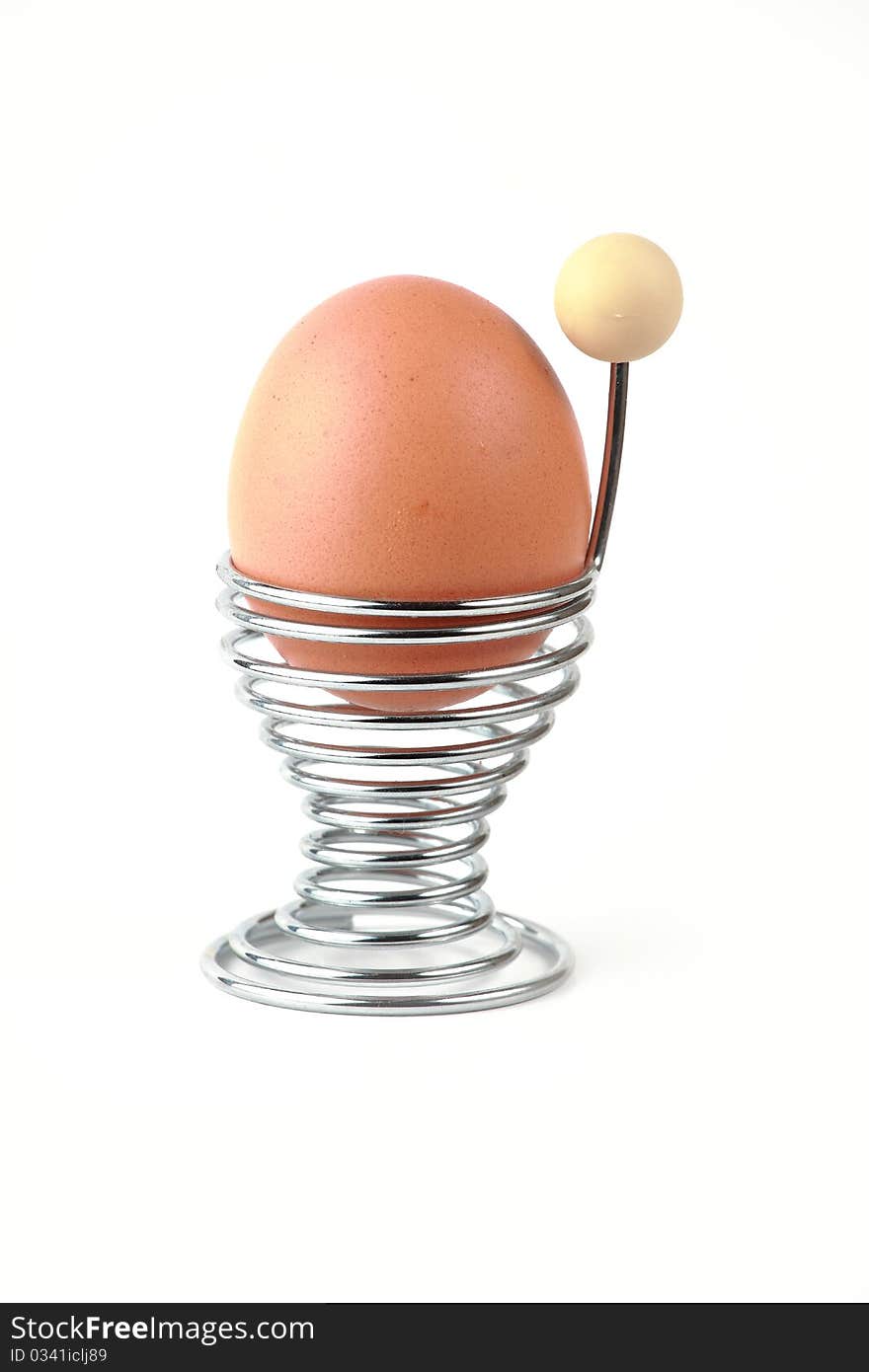 Boiled egg isolated on white in chrome egg cup