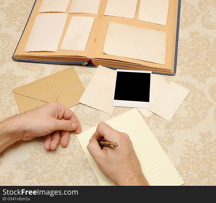 Male hands write letter on table. Male hands write letter on table