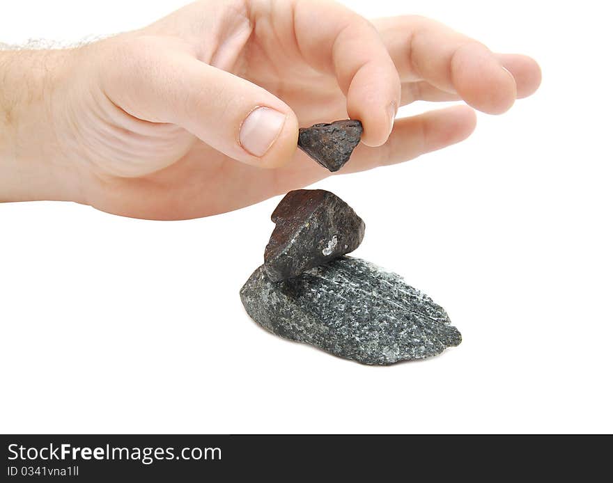 Human hand and several stones on white