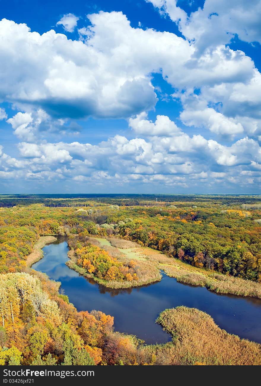 Autumnal forest, river and sky (view from above). Autumnal forest, river and sky (view from above).