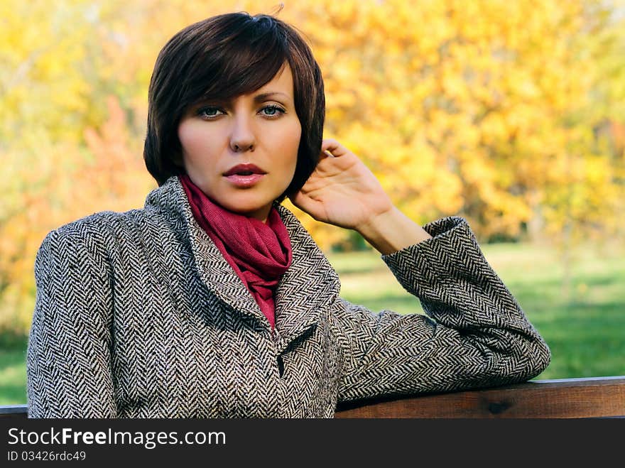 Woman in the autumn forest in the coat