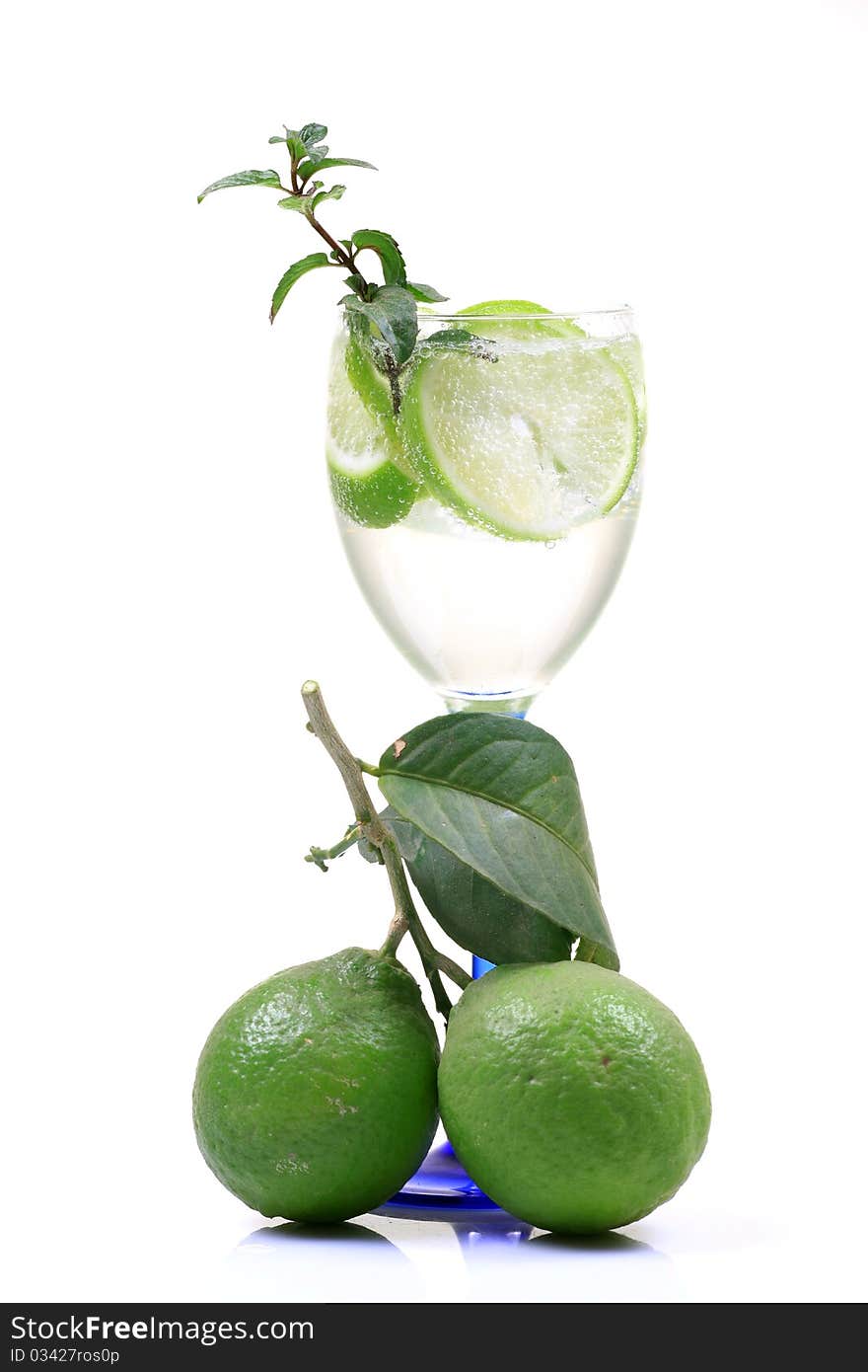 Fresh lime water glass with lime isolated on white background.