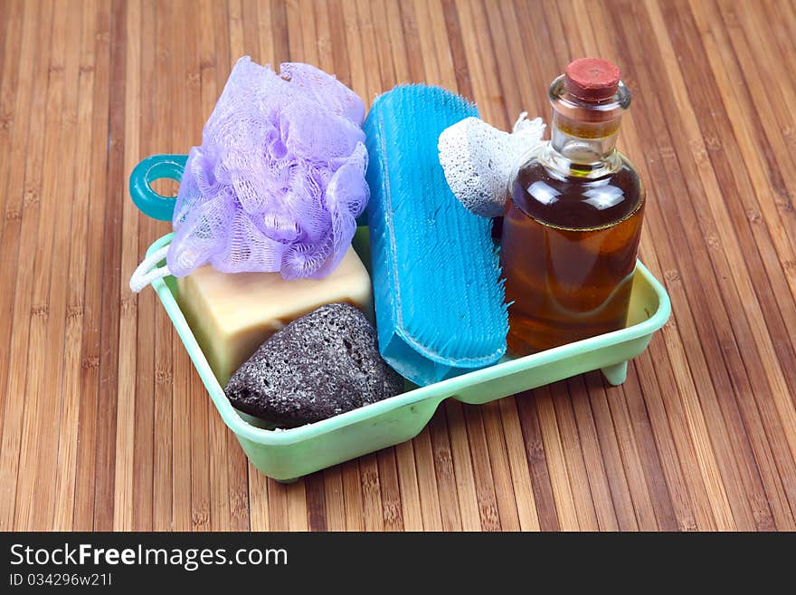 Washing items brush, soap, oil etc on wooden background.