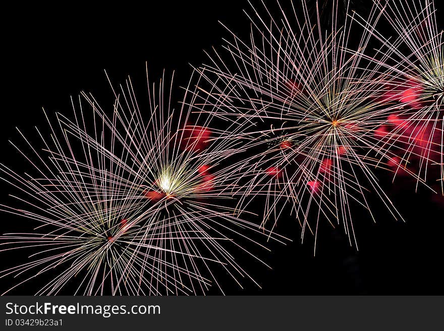 Colorful Fireworks display with copy space left or right.