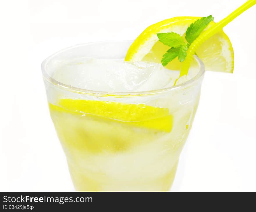 Yellow lemonade with ice and lemon