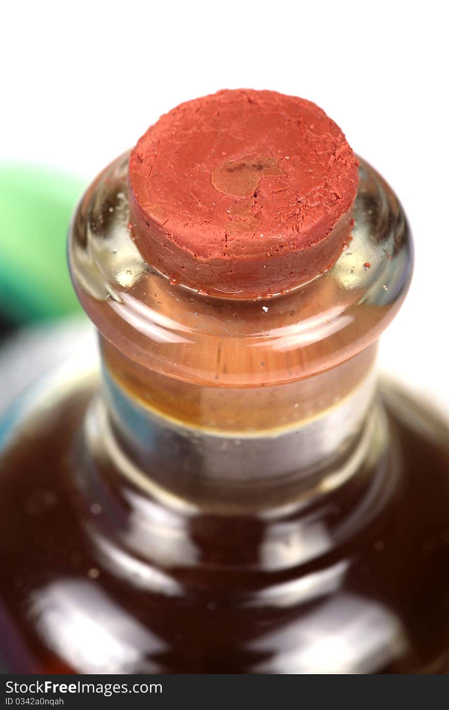 Closeup shot of cork stuck in oil bottle mouth.