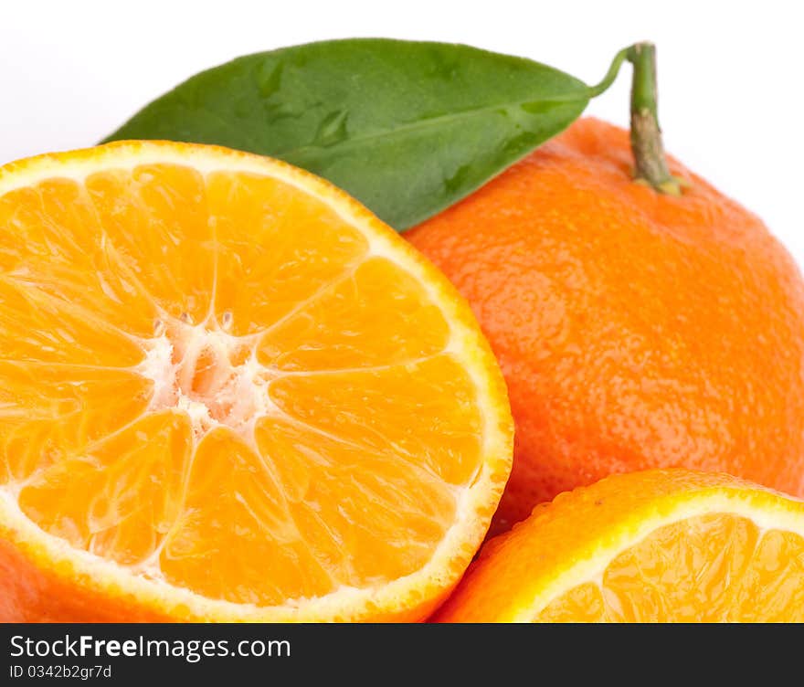 Tangerines with green leaves isolated on white.