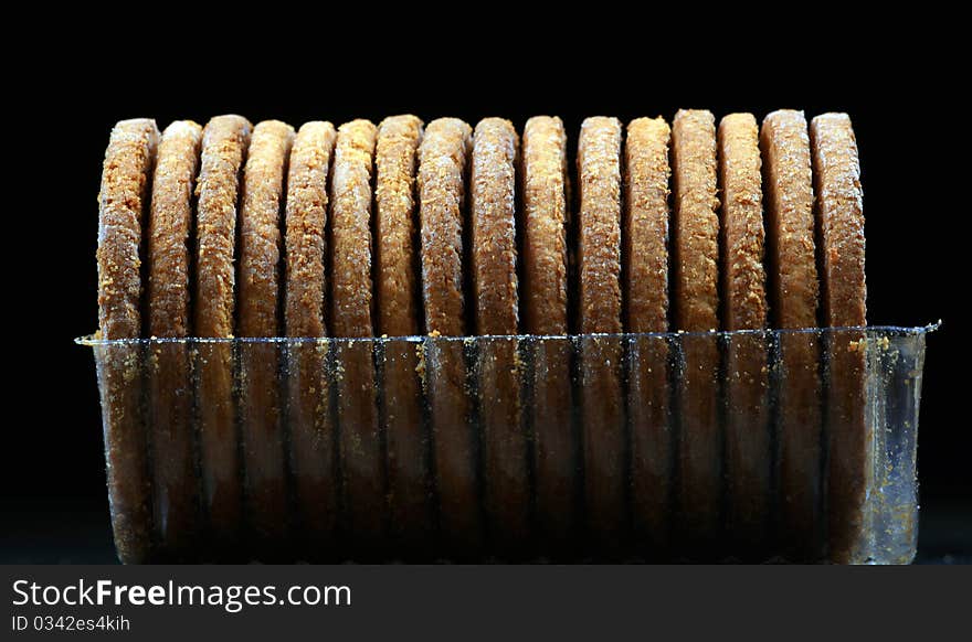 Diet bicuits in tray isolated on black background.