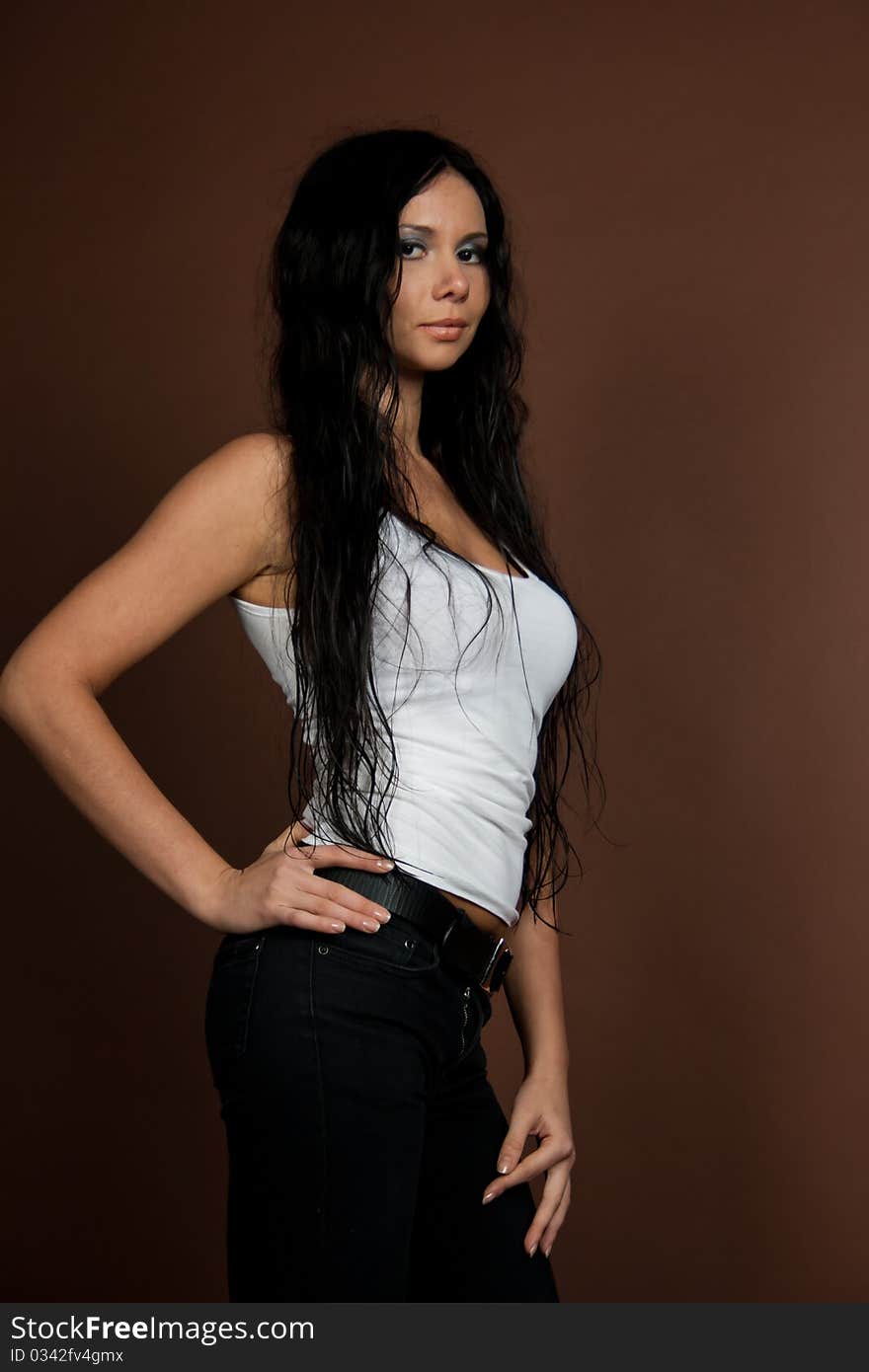 glamorous girl with wet hair in white T-shirt isolated on brown background. glamorous girl with wet hair in white T-shirt isolated on brown background