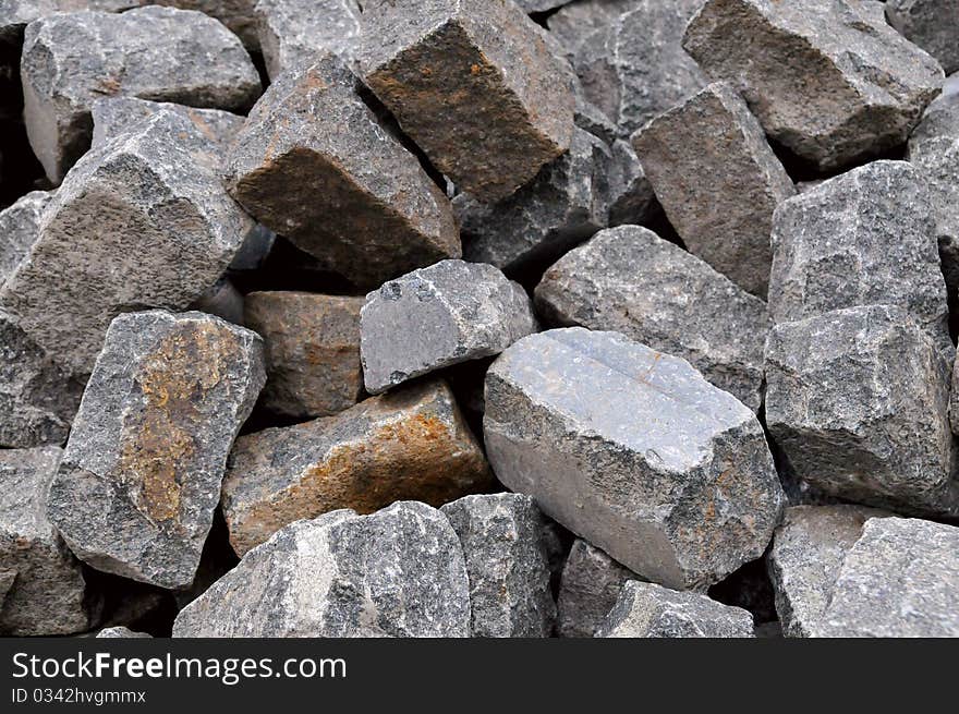 Pile of natural gray stone bricks closeup