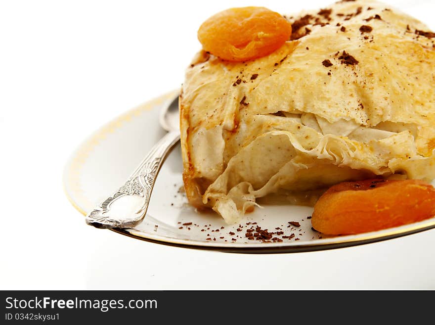 Homemade apple pie with a spoon on white background