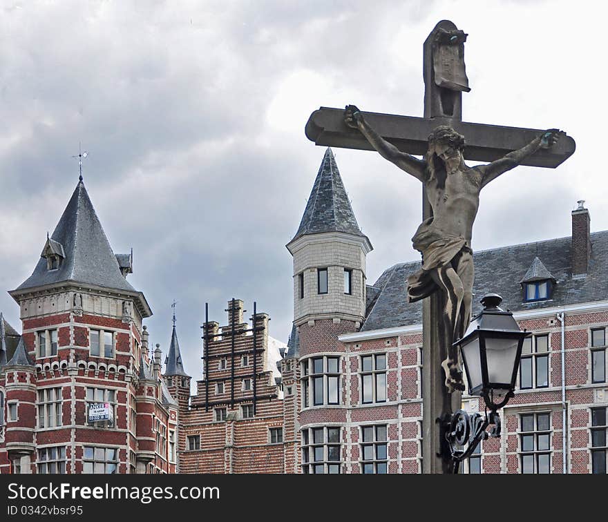 Statue of Jesus - Crucifixion against ancient buildings in Antwerp. Statue of Jesus - Crucifixion against ancient buildings in Antwerp