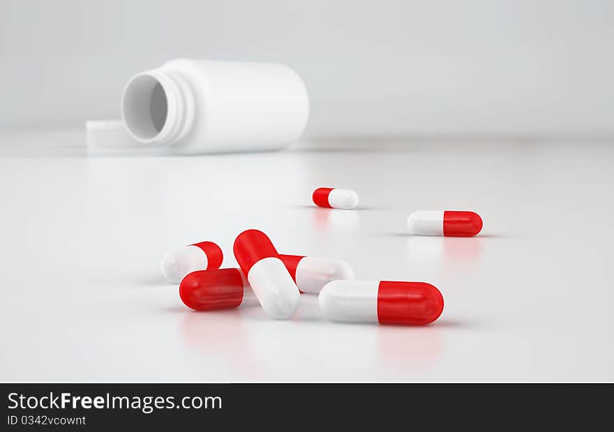 Red and white capsules on white reflective floor with white bottle on background. XXXL size image. Red and white capsules on white reflective floor with white bottle on background. XXXL size image.