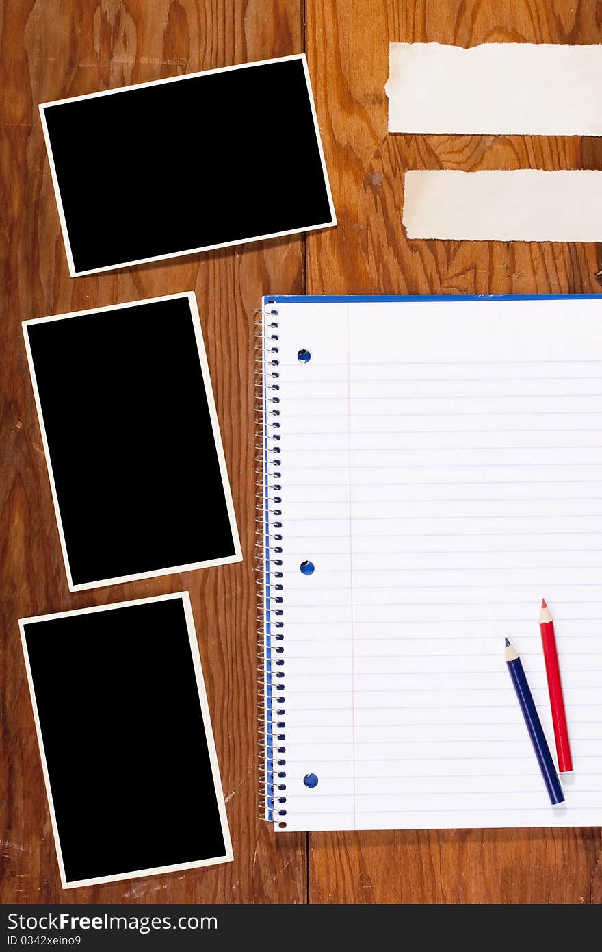 Notebook and Information clean sheets on the old wooden background.