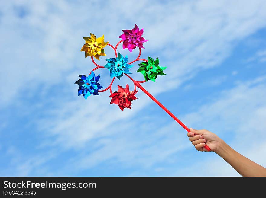 Colorful Multi Pinwheels Against Blue Sky