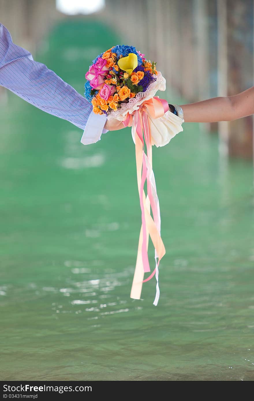 Two Hand Holding Beautiful Flower Bouquet