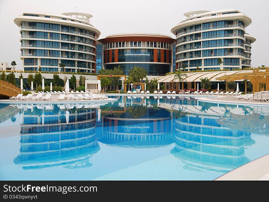 Luxury hotel with reflection in the pool. Turkey, Antalia.