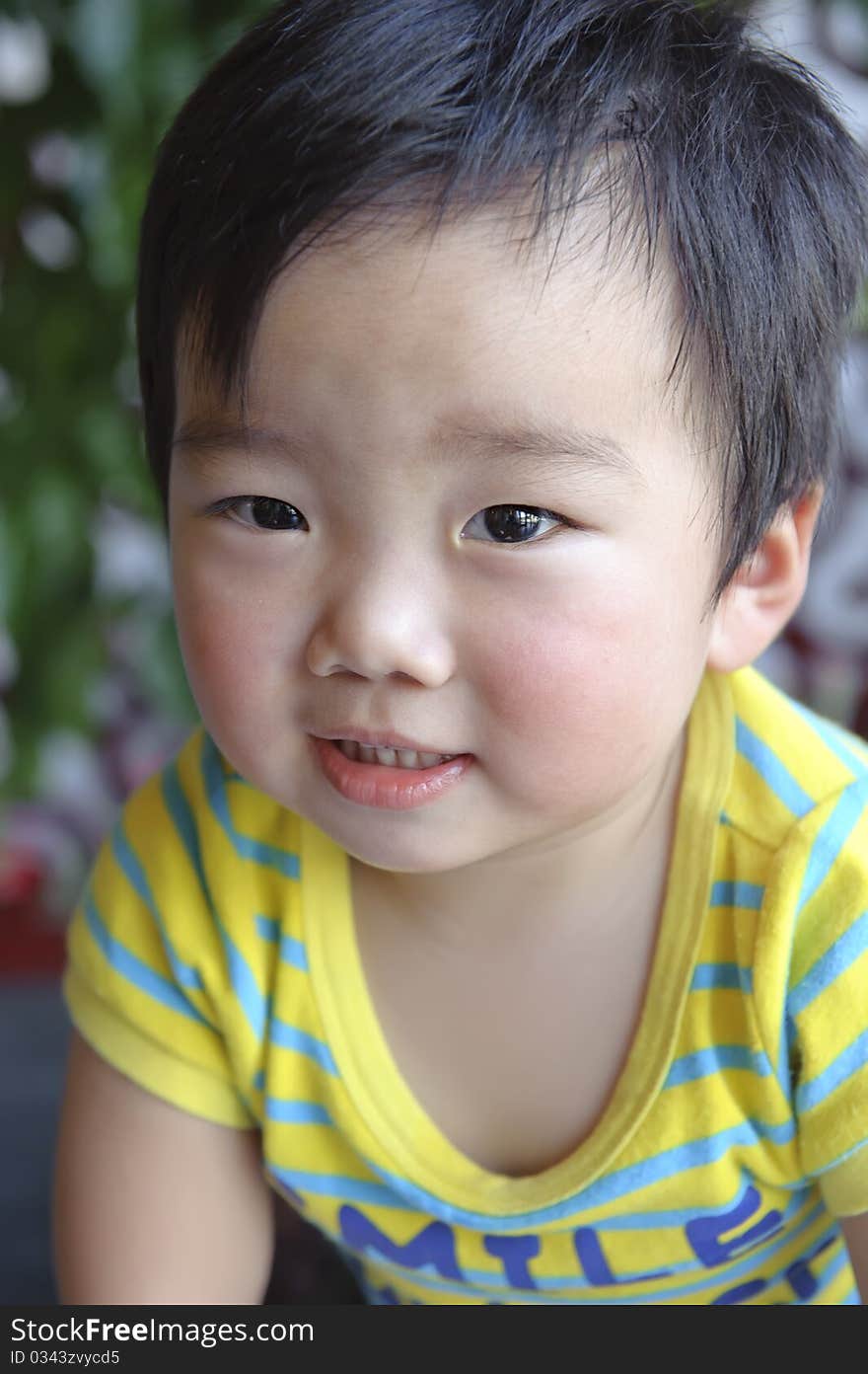 A cute baby is looking at photographer. A cute baby is looking at photographer