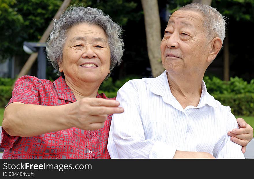 An intimate senior couple in a garden. An intimate senior couple in a garden