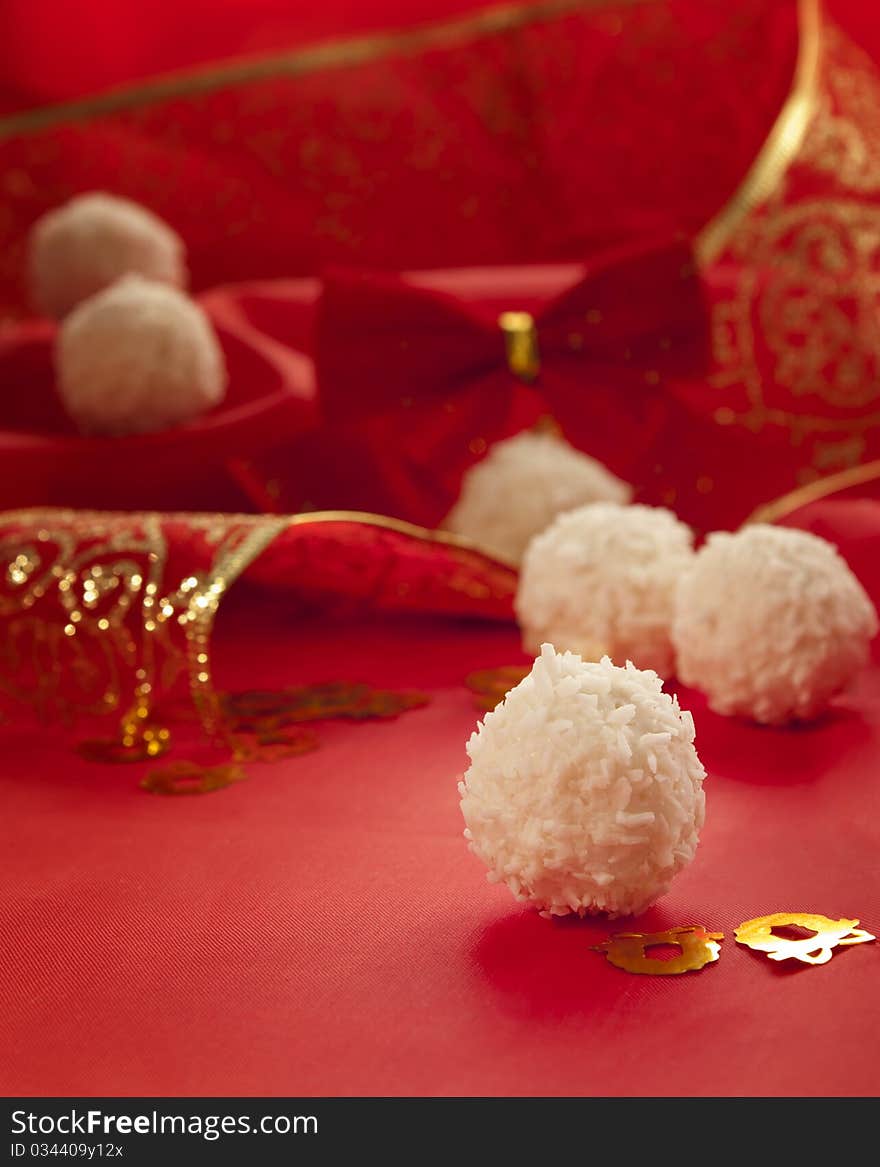 Arrangement of coconut cookies on red elegant background.