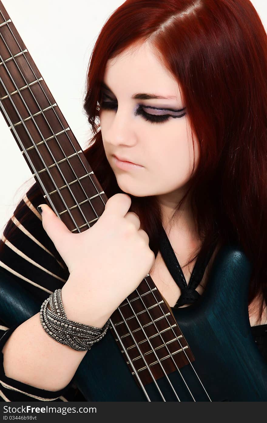 Beautiful 19 year old girl with 5 string electric bass guitar. Beautiful 19 year old girl with 5 string electric bass guitar.