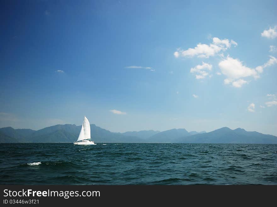 Sailboat sails through the sea. Sailboat sails through the sea