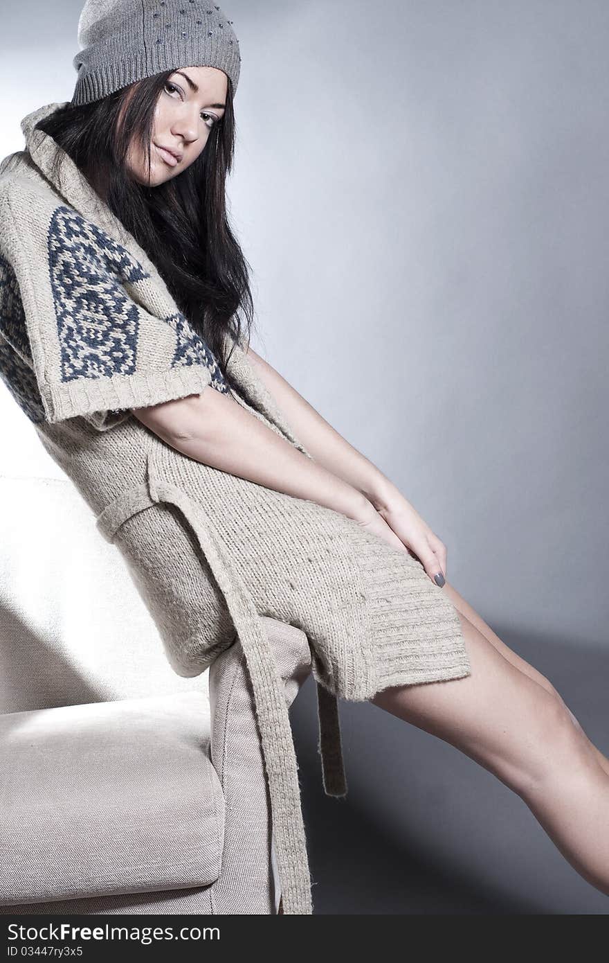 Beautiful young girl sitting on the chair