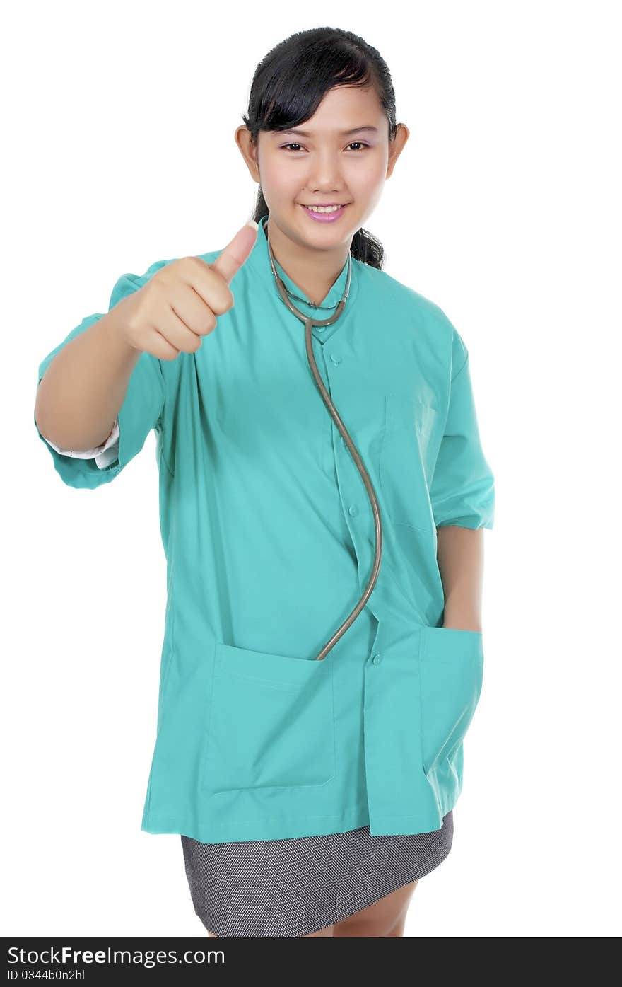 A Doctor wearing scrub show her thumb isolated over white background. A Doctor wearing scrub show her thumb isolated over white background