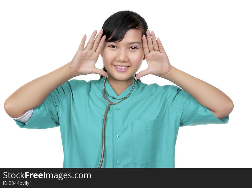 A Doctor wearing scrub framing her face isolated over white background. A Doctor wearing scrub framing her face isolated over white background