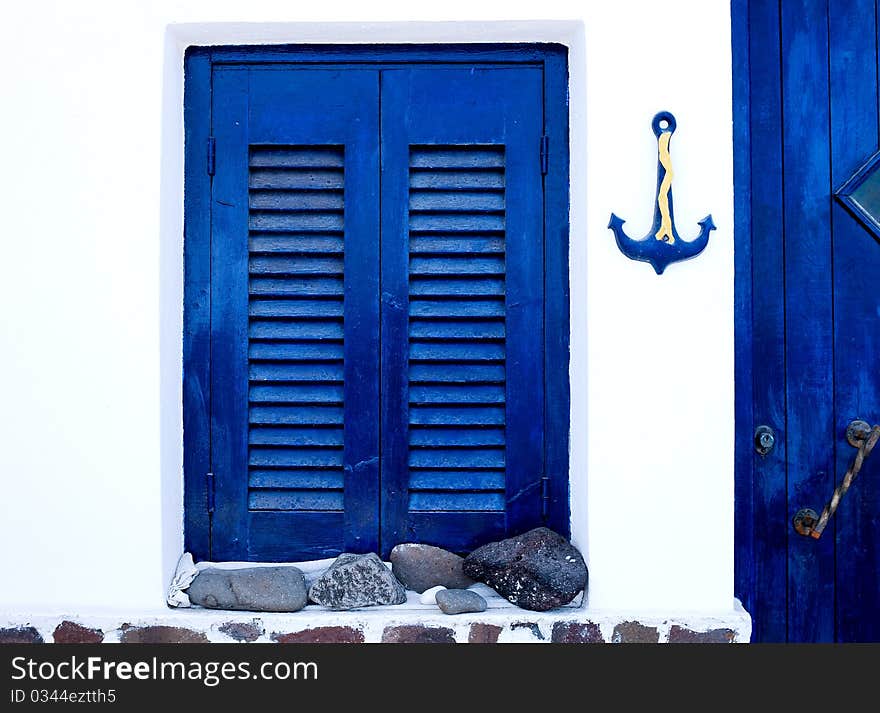 Exterior of a traditional house in Santorini Island, with the blue and white as the major colors. Exterior of a traditional house in Santorini Island, with the blue and white as the major colors