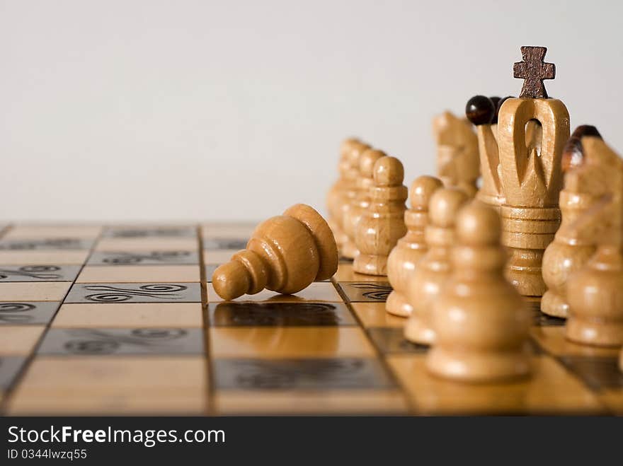 Figures of chess on the chessboard on the white background. Figures of chess on the chessboard on the white background