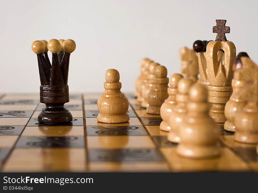 Figures of chess on the chessboard on the white background. Figures of chess on the chessboard on the white background