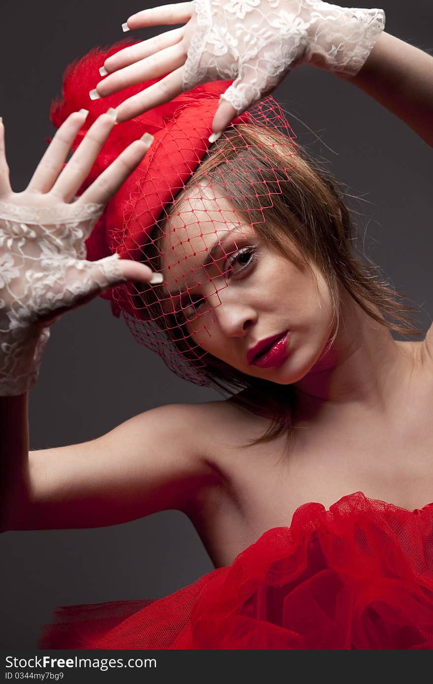 Beautiful woman in red hat with net veil. Retro portrait. Beautiful woman in red hat with net veil. Retro portrait