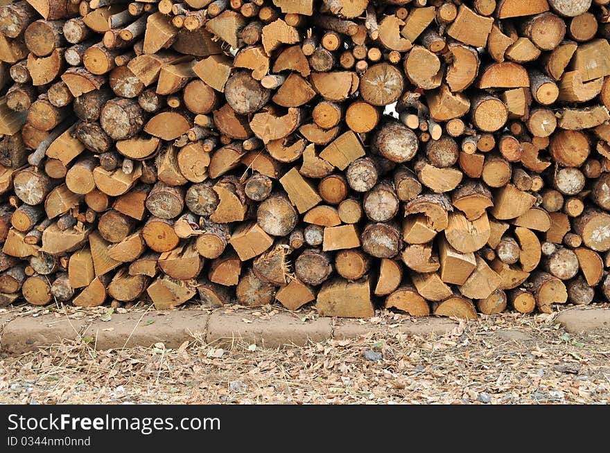 Logs of firewood in a nice stack, all piled up together.