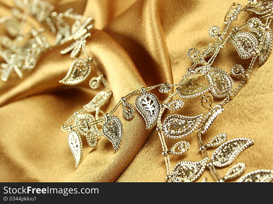 Background of gold cloth on which lay the golden jewelry. Background of gold cloth on which lay the golden jewelry