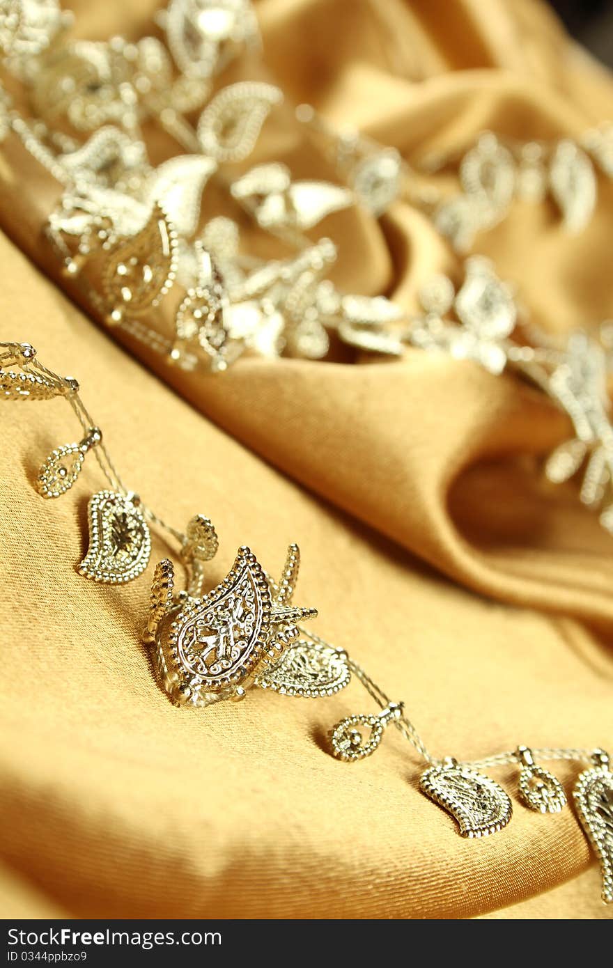 Background of gold cloth on which lay the golden jewelry. Background of gold cloth on which lay the golden jewelry