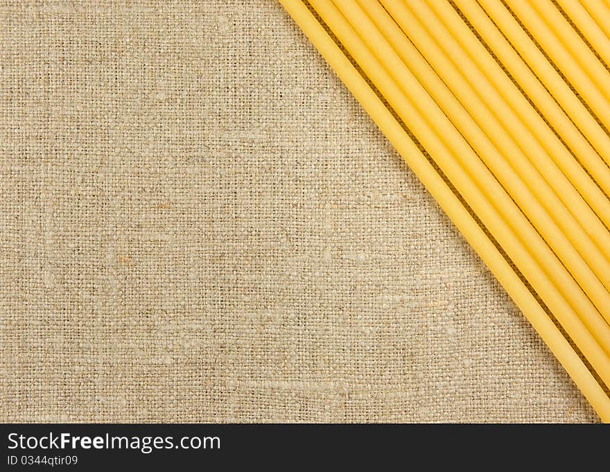 Raw spaghetti on the burlap background