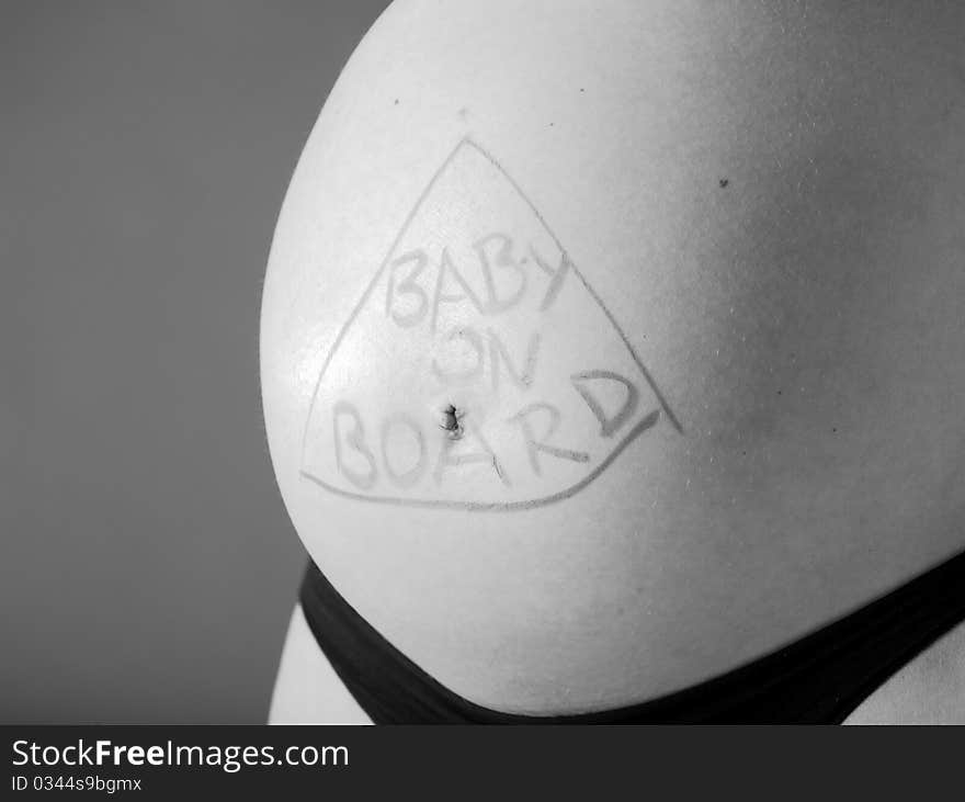 Expectant mother with writing baby on board