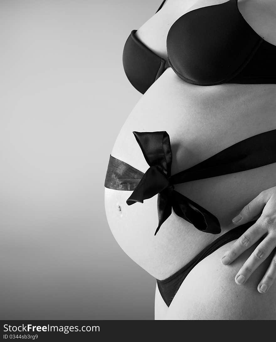 Expectant mother with ribbon in black and white