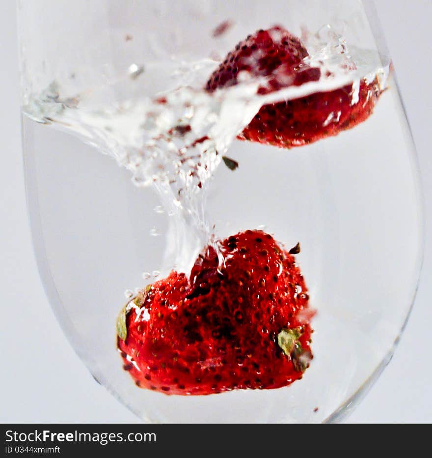 Red strawberry in water in a glass. Red strawberry in water in a glass