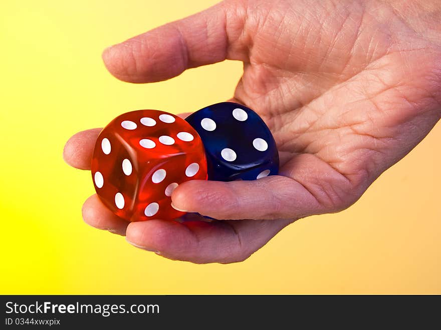 Red and blue dices in hand