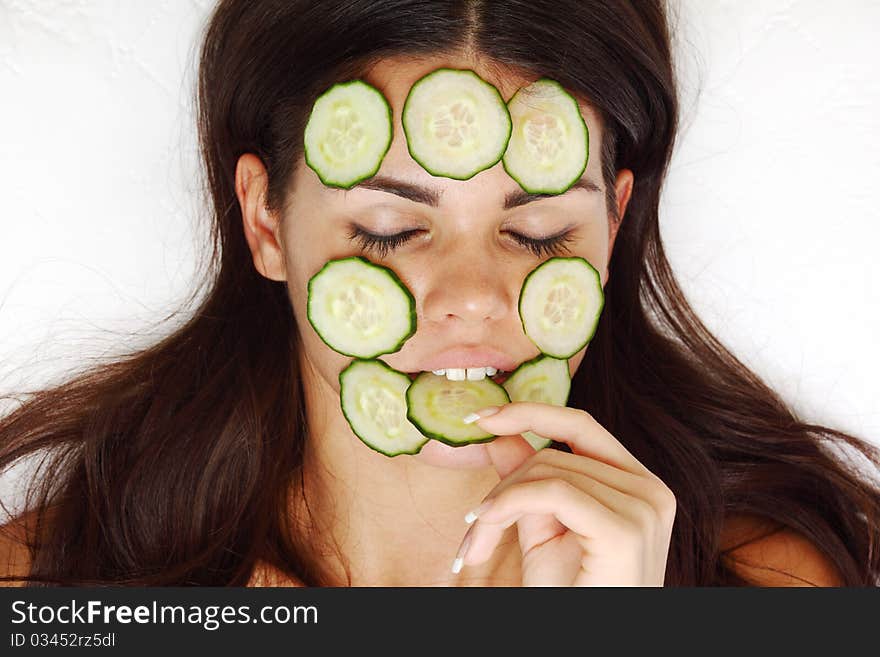 Cucumbers circles on a girl face. Cucumbers circles on a girl face