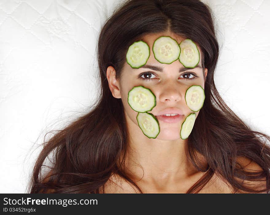 Cucumbers circles on a girl face. Cucumbers circles on a girl face