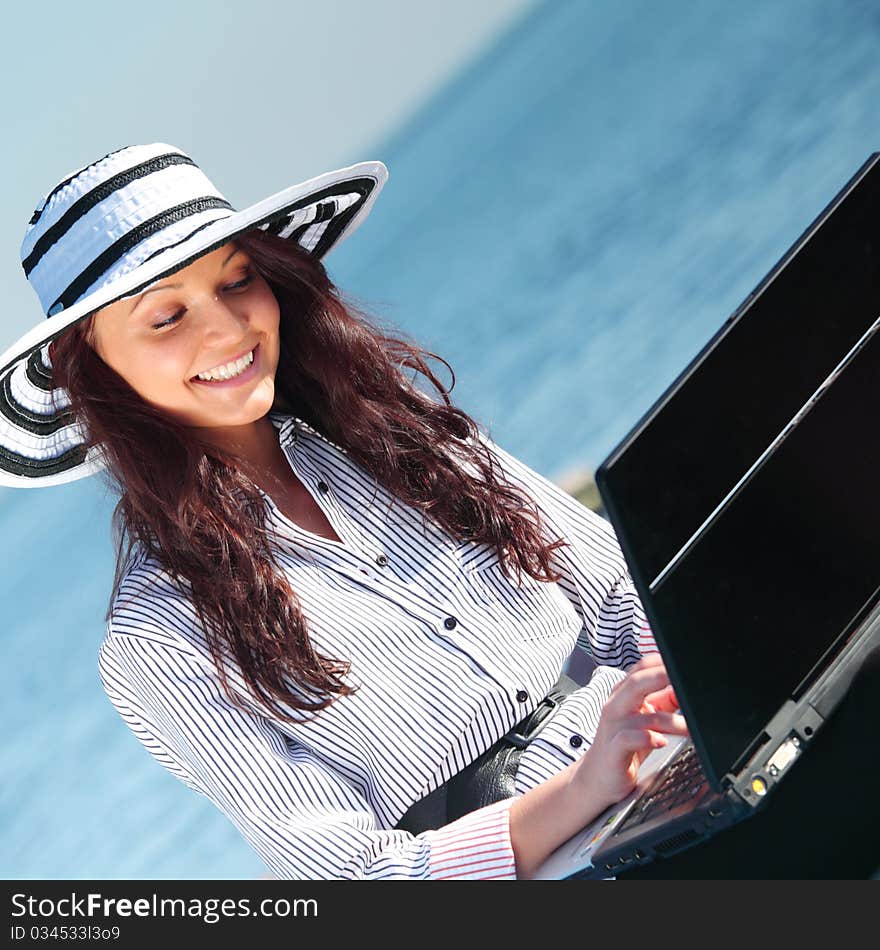 Woman with laptop sea background. Woman with laptop sea background