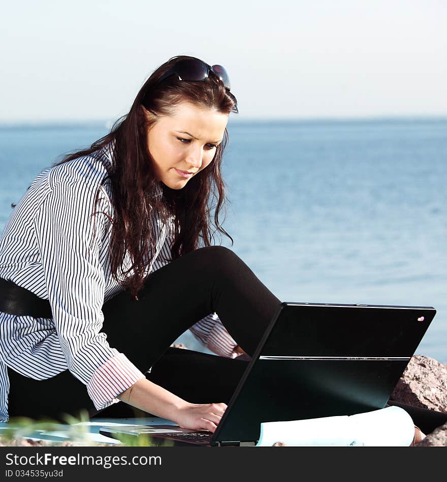 Woman with laptop sea background. Woman with laptop sea background