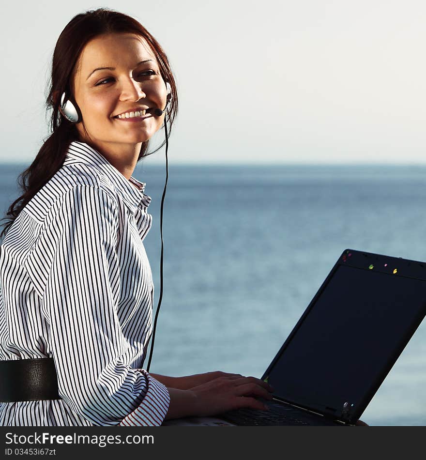 Woman with laptop sea background. Woman with laptop sea background